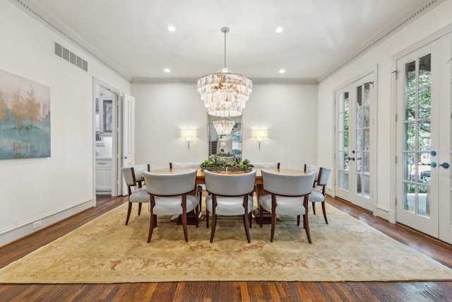 dining area featuring french doors, crown molding, a chandelier, and wood-type flooring