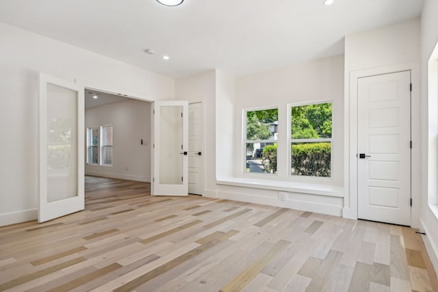 unfurnished room featuring light hardwood / wood-style flooring and french doors