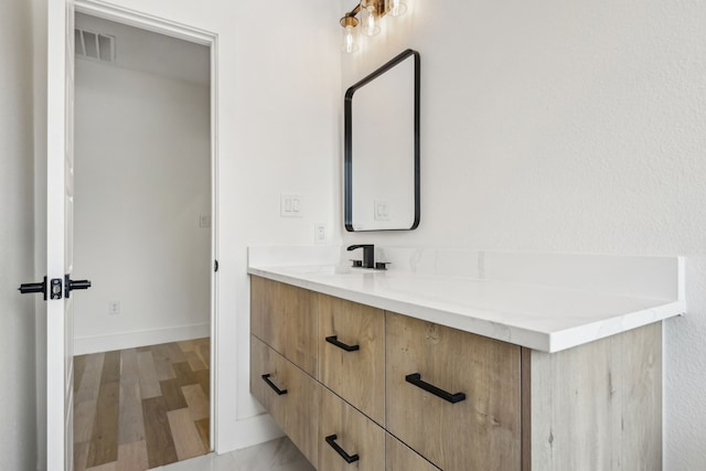 bathroom featuring wood-type flooring and vanity