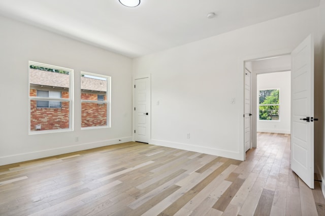 spare room with light hardwood / wood-style floors