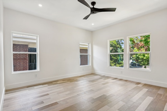 empty room with light hardwood / wood-style floors and ceiling fan