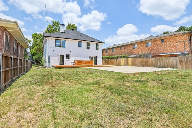 rear view of house featuring a yard and a patio