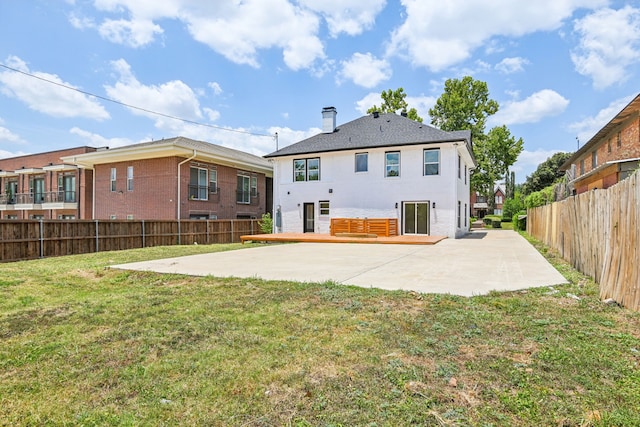 rear view of house with a lawn and a patio area