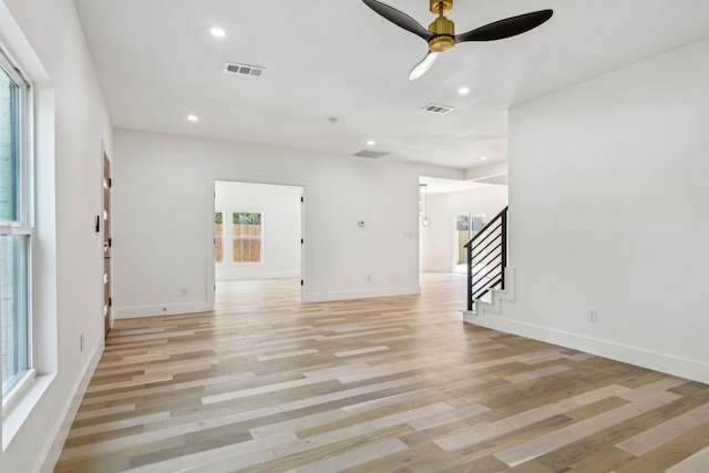 unfurnished living room with ceiling fan and light hardwood / wood-style floors