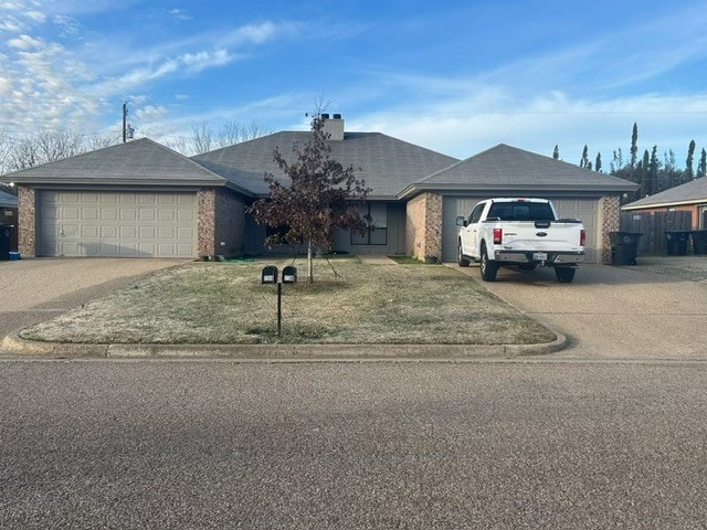 single story home with a front yard and a garage