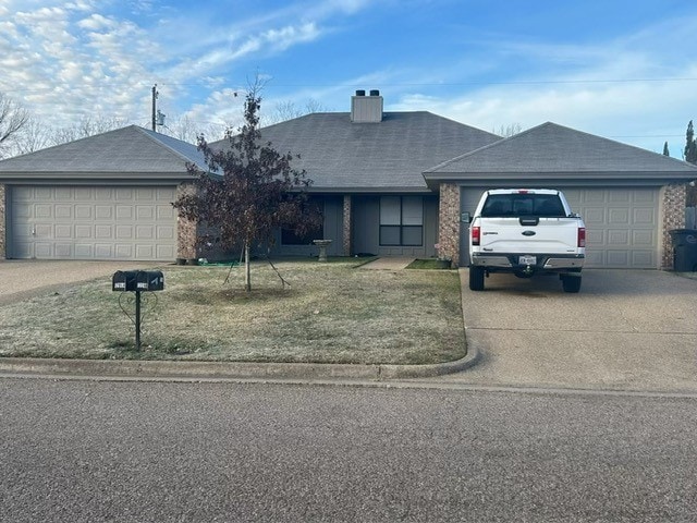 ranch-style home featuring a front yard and a garage