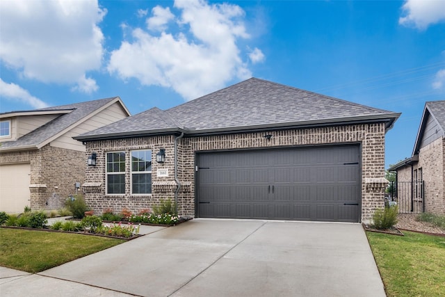 view of front of property with a front lawn and a garage