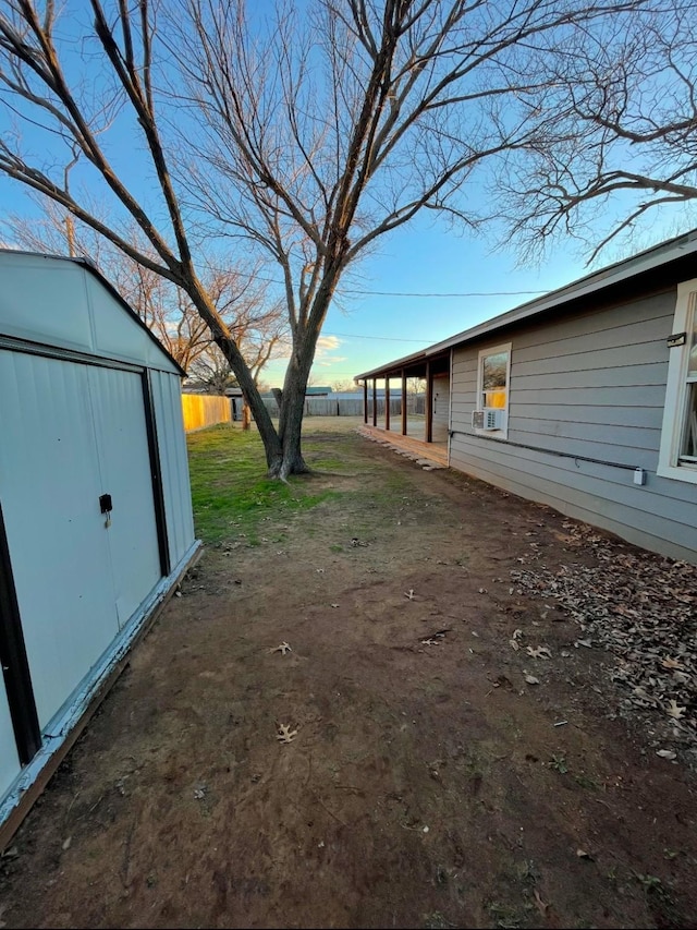 view of yard with a storage unit