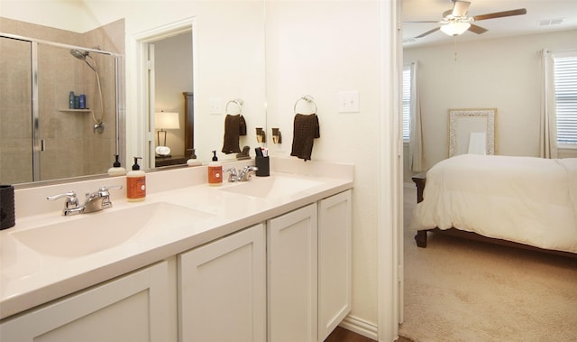 bathroom featuring ceiling fan, vanity, and a shower with shower door