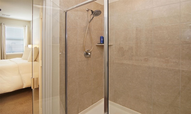 bathroom featuring a shower with door