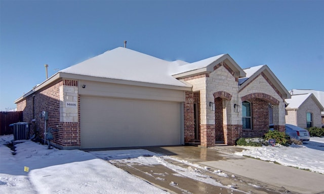 view of front facade with central AC and a garage