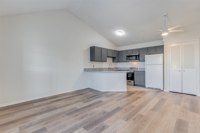 kitchen featuring stainless steel appliances, ceiling fan, light hardwood / wood-style flooring, kitchen peninsula, and high vaulted ceiling