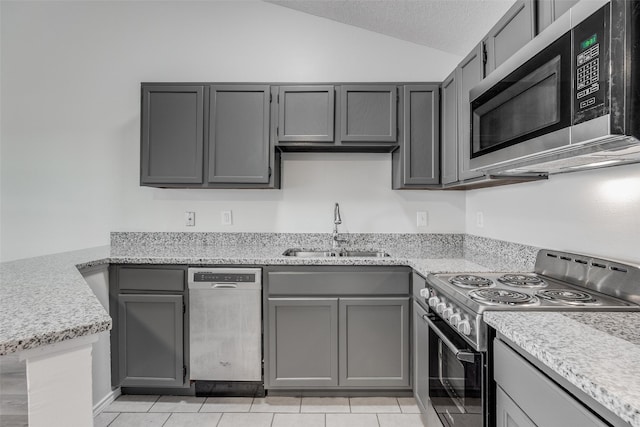 kitchen with gray cabinetry and appliances with stainless steel finishes