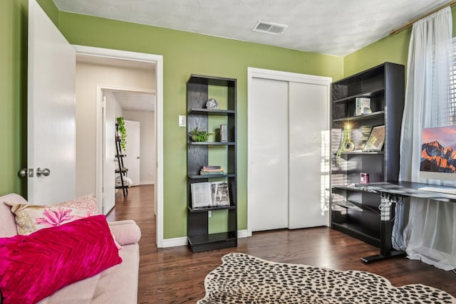 interior space featuring visible vents, baseboards, and wood finished floors