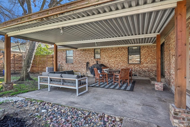 view of patio featuring outdoor lounge area and fence