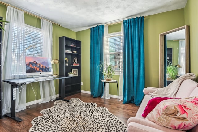 sitting room featuring baseboards and wood finished floors