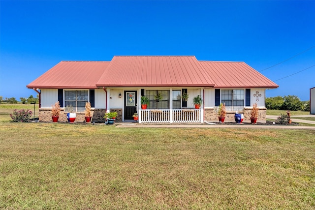 view of front of property with metal roof, stone siding, a porch, and a front yard