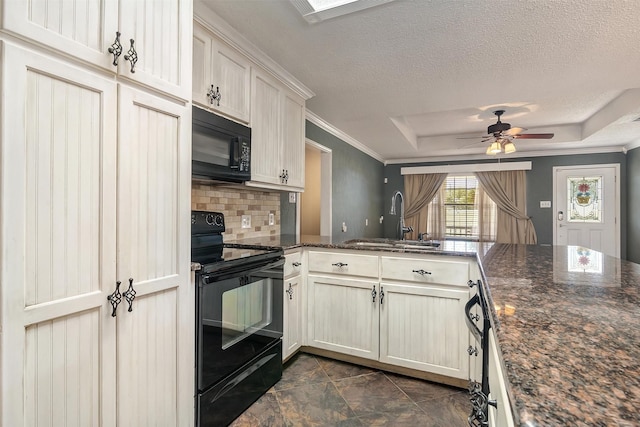 kitchen with sink, ceiling fan, kitchen peninsula, dark stone counters, and black appliances