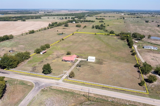 birds eye view of property with a rural view