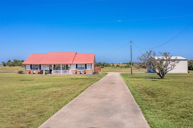 view of front of house with a front yard and metal roof