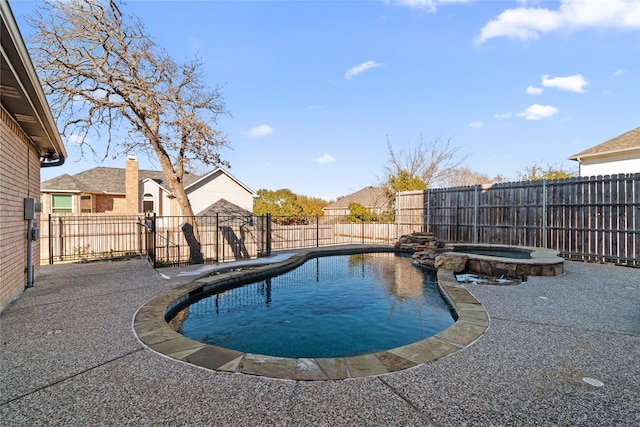 view of pool with a patio area and an in ground hot tub