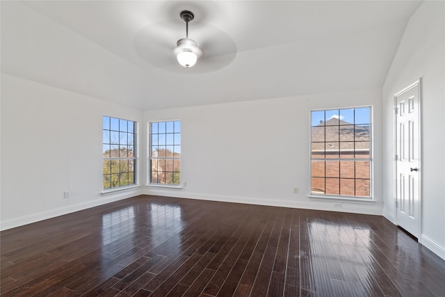 empty room featuring vaulted ceiling, dark wood-type flooring, and ceiling fan