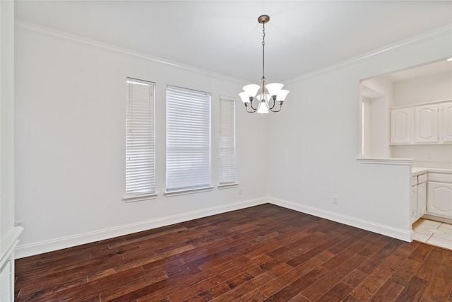 unfurnished dining area with an inviting chandelier, hardwood / wood-style floors, and crown molding