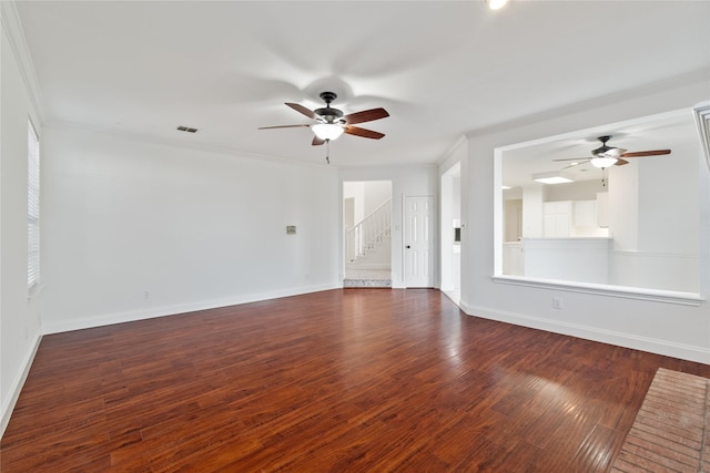 spare room with crown molding and dark hardwood / wood-style flooring