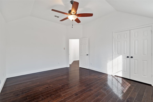 unfurnished bedroom featuring vaulted ceiling, ceiling fan, a closet, and dark hardwood / wood-style floors