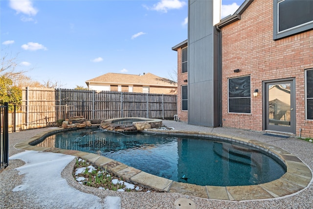 view of pool with an in ground hot tub