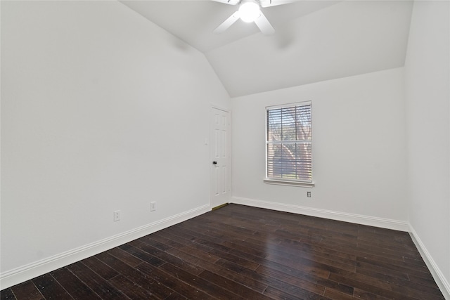 empty room with dark wood-type flooring, ceiling fan, and vaulted ceiling