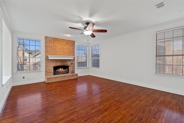 unfurnished living room featuring a brick fireplace, ceiling fan, and crown molding