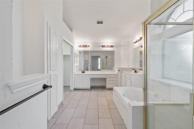 bathroom featuring separate shower and tub, a wealth of natural light, and vanity