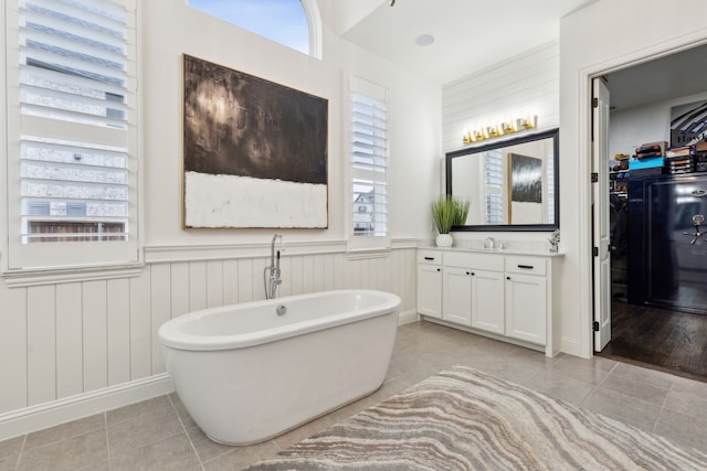 bathroom with vanity, tile patterned floors, and a tub