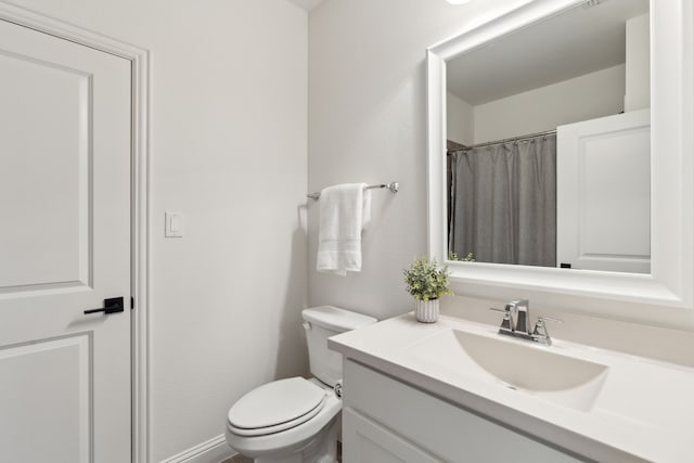 bathroom with vanity, toilet, and walk in shower