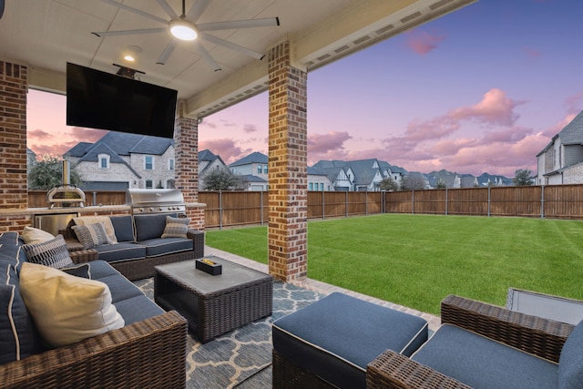 view of patio with ceiling fan, an outdoor kitchen, an outdoor living space, and area for grilling