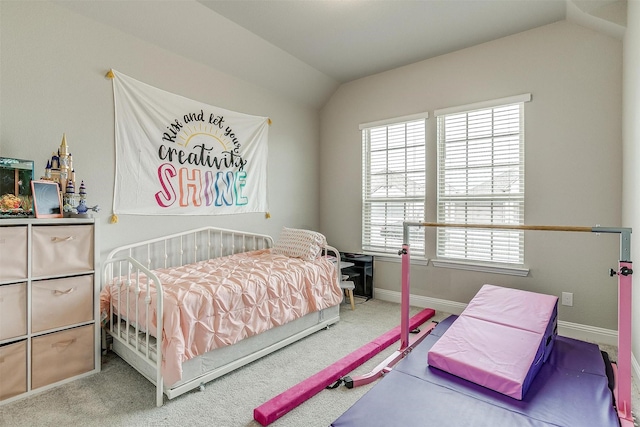 carpeted bedroom with lofted ceiling