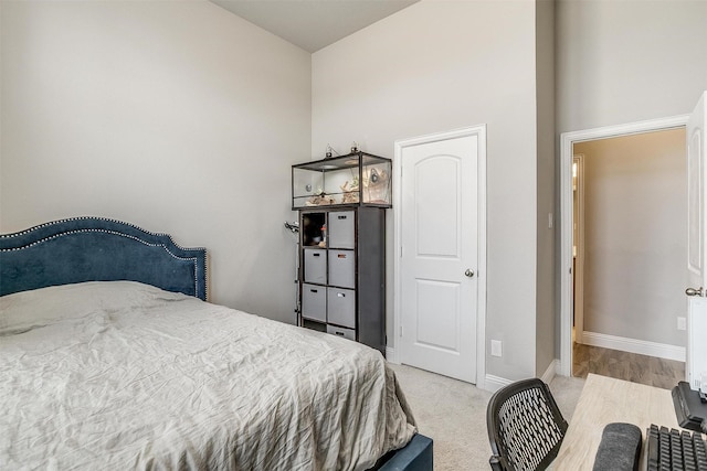 carpeted bedroom with a high ceiling