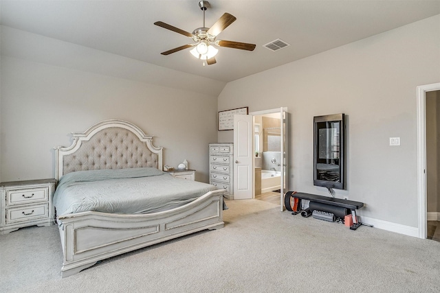 bedroom with connected bathroom, light carpet, ceiling fan, and vaulted ceiling