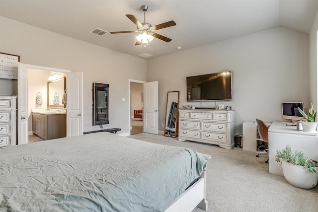 carpeted bedroom featuring ceiling fan, ensuite bath, and lofted ceiling