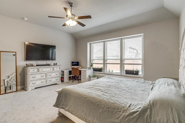 carpeted bedroom featuring connected bathroom, ceiling fan, and vaulted ceiling