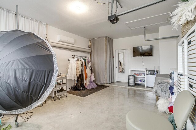 interior space with concrete floors and a wall mounted air conditioner