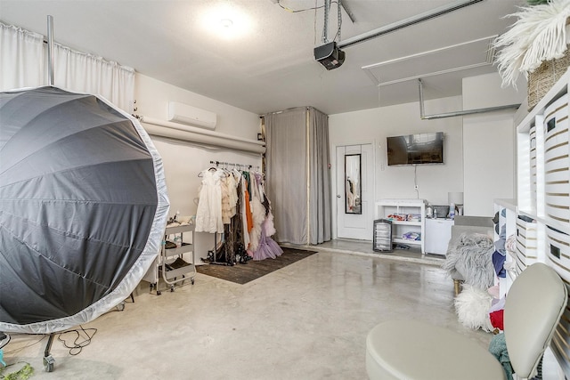 garage featuring a garage door opener and a wall unit AC