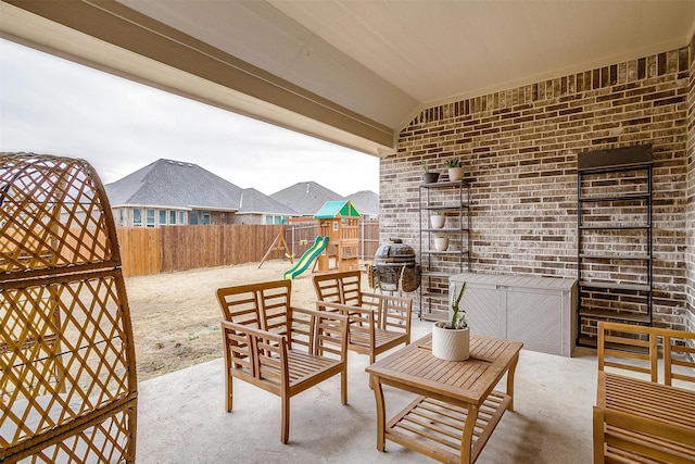 view of patio / terrace featuring area for grilling, a playground, and outdoor lounge area