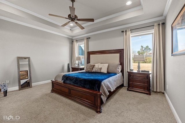 bedroom with ornamental molding, ceiling fan, a tray ceiling, and light carpet