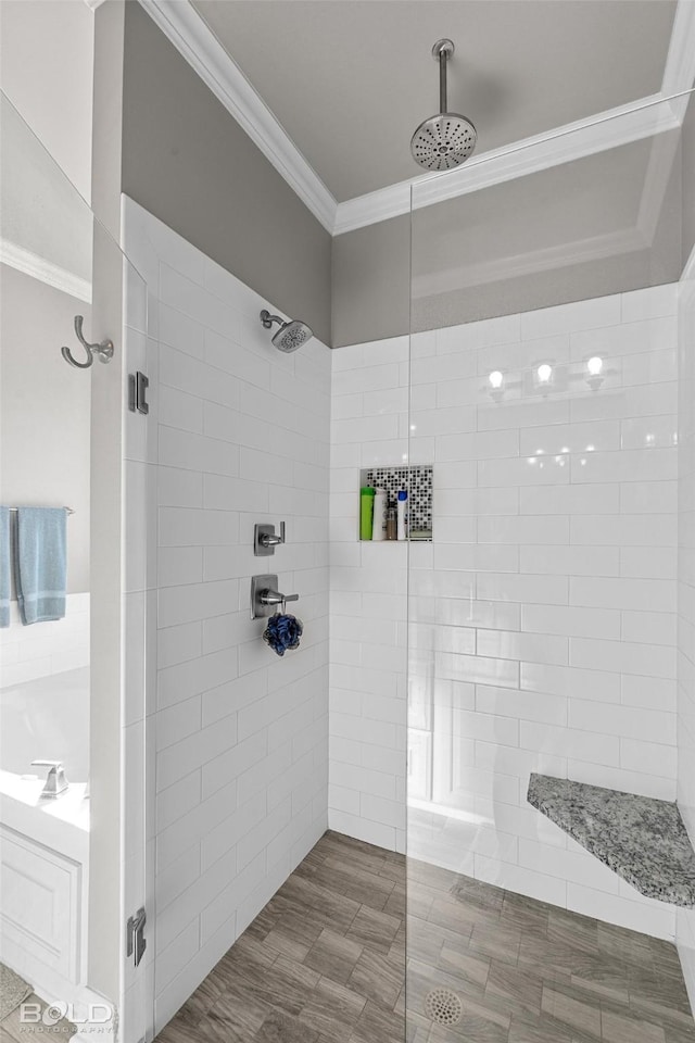 bathroom with crown molding and a tile shower