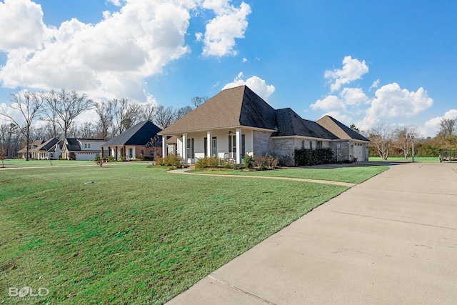 view of front of home with covered porch and a front lawn