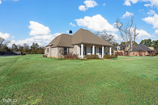 french country inspired facade featuring central air condition unit and a front yard