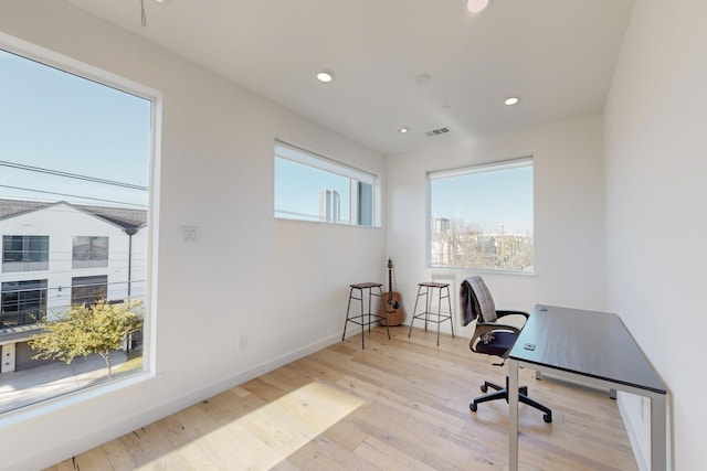 office with light wood-type flooring