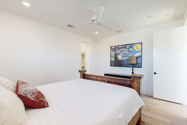 bedroom with ceiling fan and light wood-type flooring